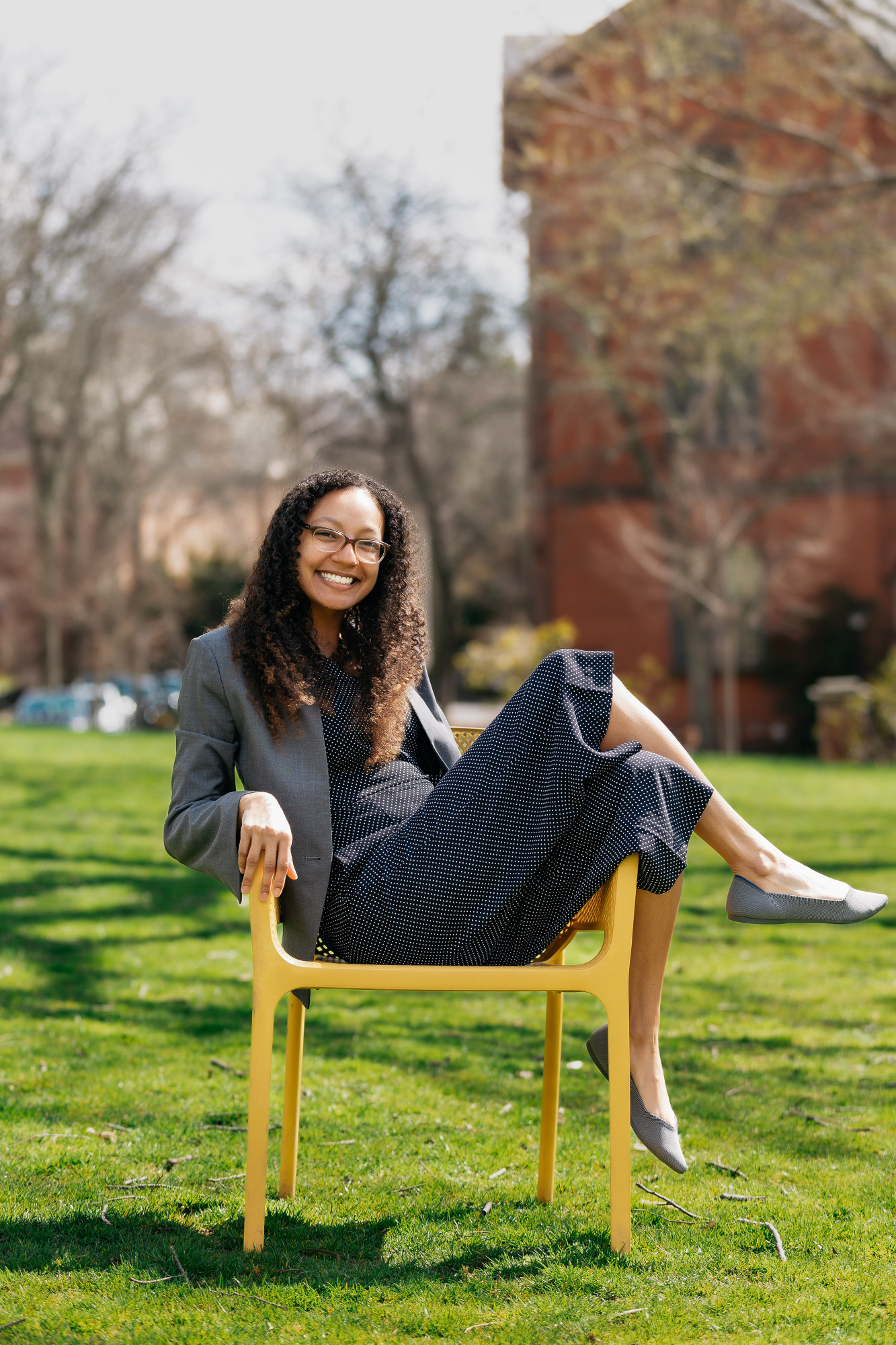 Alexandria (Alex) Macmadu poses in a chair outside, smiling