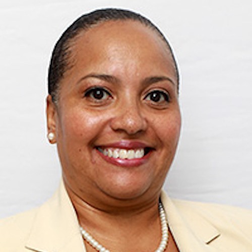 Headshot of Candace Harper wearing a pale blazer and smiling at the camera.