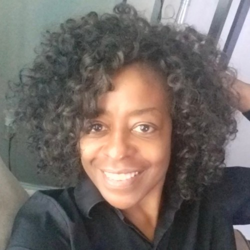 Headshot of Gloria Johnson wearing a black shirt and smiling.