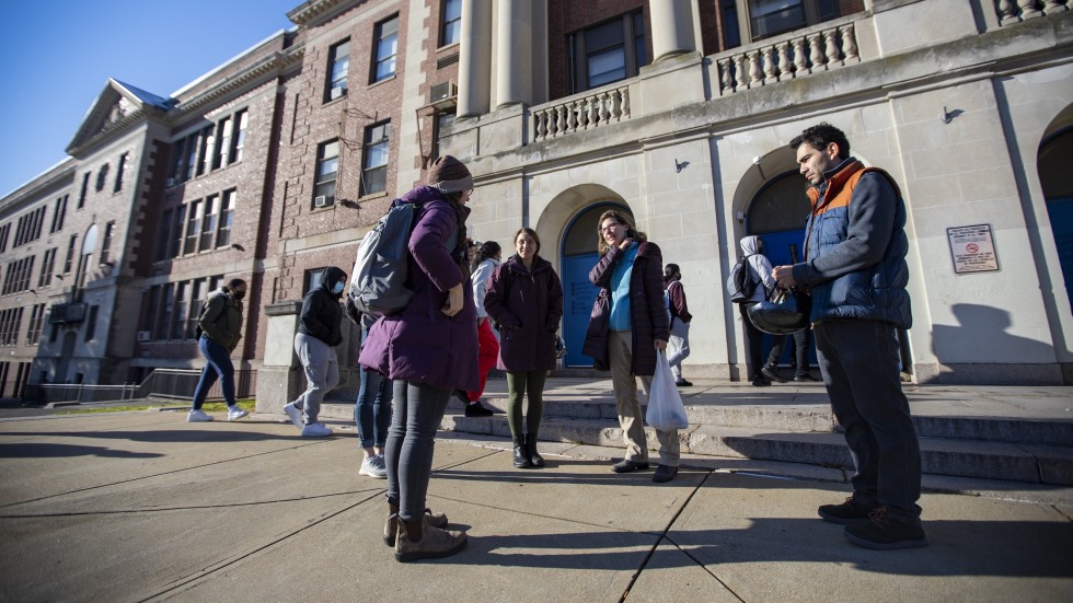group of people talking outside of a building