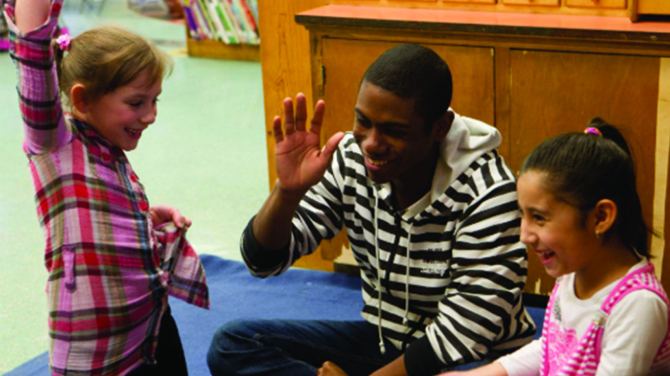 student high-fiveing child