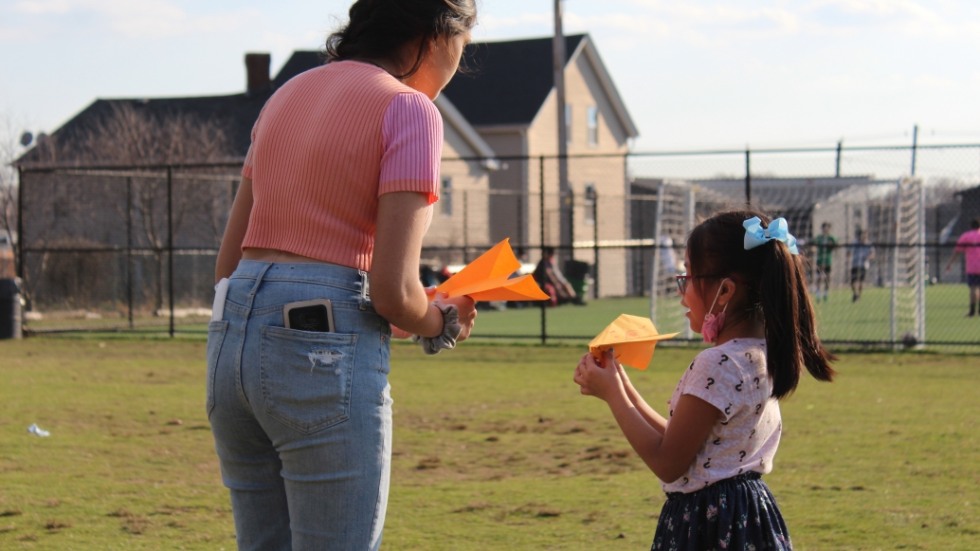 A D'Abate student and adult holding paper airplanes