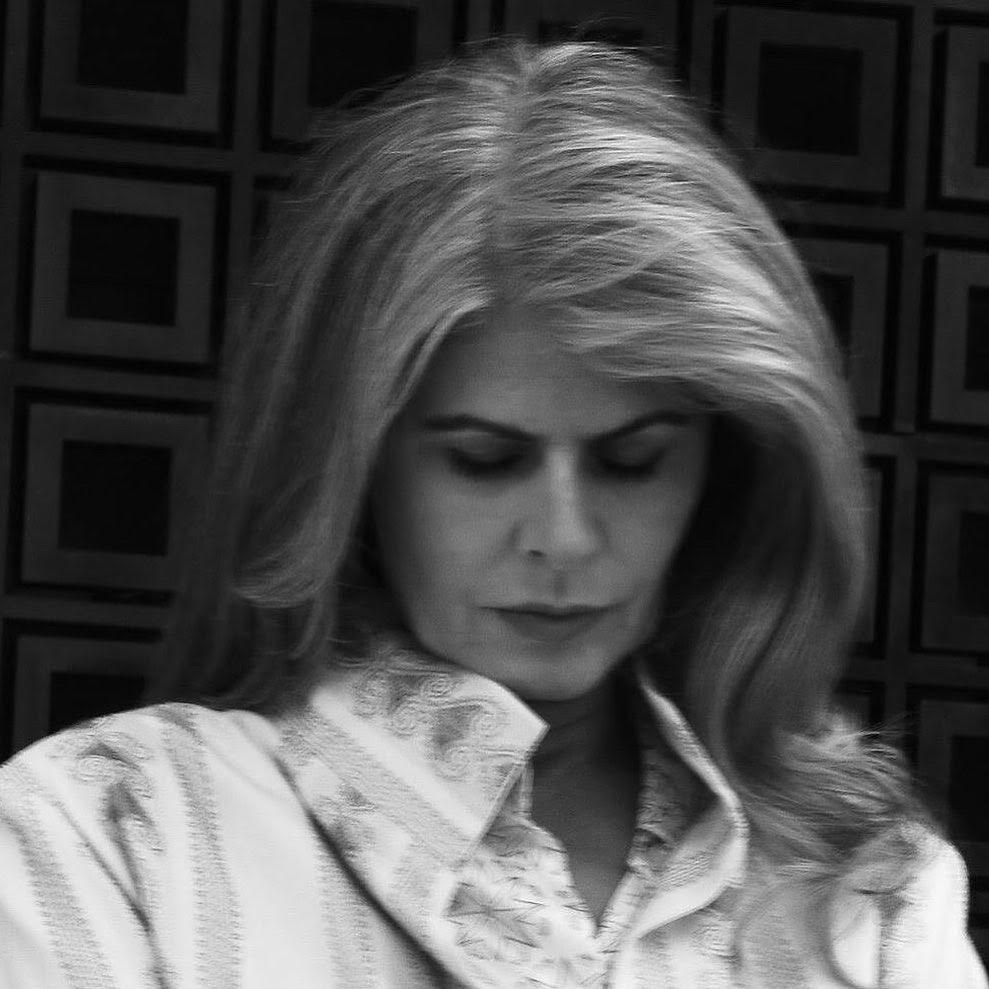 Headshot of Eleni Sikelianos, looking down